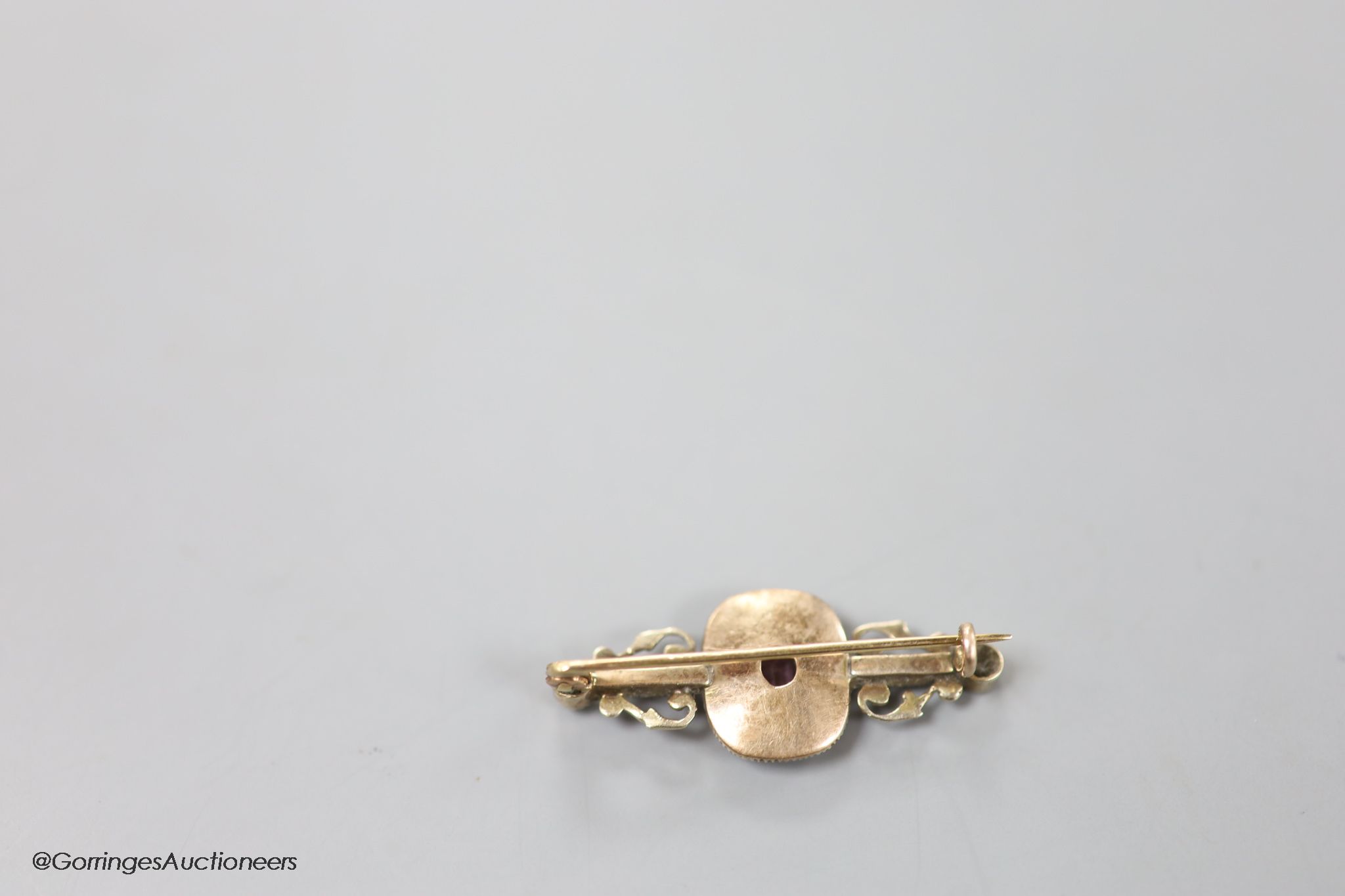 A late Victorian yellow metal, pink spinel?, green garnet, seed pearl and rose cut diamond set bar brooch, 35mm, gross weight 4.2 grams.